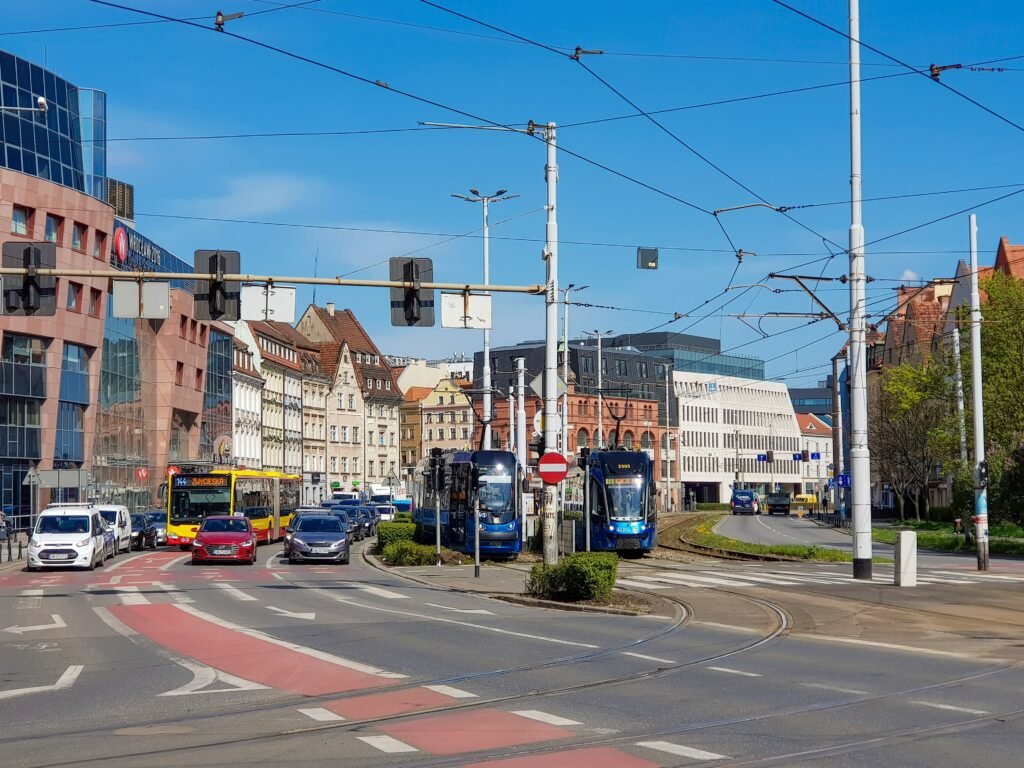 a city street filled with traffic next to tall buildings